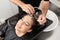 Hairdressers Hand Washing Customer\'s Hair