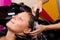 Hairdressers hand washing female customer\'s hair