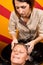 Hairdressers hand washing female customer\'s hair in salon