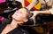 Hairdressers hand washing female customer\'s hair in salon