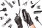 Hairdressers hands in black rubber gloves holds hair clipper and scissors surrounded by professional hairdressing accessories