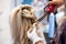 Hairdressers hands with a circle of scissors hair styled blonde