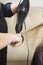 Hairdressers hands drying long blond hair