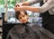 Hairdressers hands making hairstyle to child little boy in the barber shop hair cut professional - Little boy in the barber shop