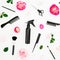 Hairdressing composition with spray, scissors, combs and roses flowers on white background. Beauty concept. Flat lay, top view