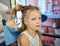 Hairdressing services. Reating hairstyle. Hair styling process. Children hairdressing salon