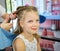 Hairdressing services. Reating hairstyle. Hair styling process. Children hairdressing salon