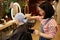 Hairstylist Applying Bleach to Short Buzzcut Hair in Beauty Salon