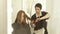 Hairstylist combing and cutting long hair with scissors in hairdressing salon. Close up hairdresser doing woman haircut
