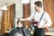 Hairstylist Combing Hair Of Boy In Barber Shop