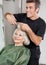 Hairstylist Cutting Client\'s Hair In Parlor