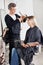 Hairstylist Cutting Customer\'s Hair In Parlor