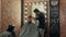 Hairstylist cutting hair to handsome client in barbershop