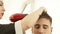 Hairstylist drying male hair after hairdressing in barber shop. Close up barber styling hair with dryer after washing