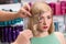 Hairstylist makes hairstyle for beautiful girl