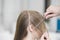 Hairstylist\'s Hand Combing Client\'s Hair Before Haircut In Salon