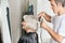 Hairstylist Straightening Customer\'s Hair