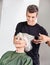 Hairstylist Straightening Senior Woman\'s Hair