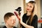 Hairstylist Styling Hairdo with Dryer and Comb