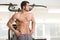 Hairy Muscular Man Flexing Muscles In Gym