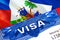 Haiti Visa in passport. USA immigration Visa for Haiti citizens focusing on word VISA. Travel Haiti visa in national