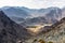 Hajar Mountains and Wadi Ghargur landscape view with transmission towers seen from Copper Hike Summit, UAE