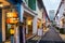 Haji Lane street in the Kampong Glam neighborhood in Singapore in the evening, full of craft boutiques, hip cafes, shophouses