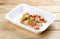 Hake fricassee with vegetables. Healthy diet. Takeaway food. On a wooden background