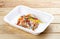 Hake fricassee with vegetables. Healthy diet. Takeaway food. On a wooden background