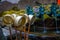 HAKONE, JAPAN - JULY 02, 2017: Bronze bowl with a stick to takle water with ablurred fountain with a bronze dragon in