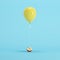 Half of apple attached to yellow balloon on blue background