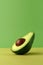 A half of avocado on color block yellow and green background