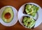 Half an avocado on a plate. Sandwiches with Avocado