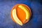 Half a banana lies on a orange plate