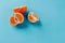 Half the clementines and a quarter on a blue background with copy space