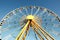 Half of a colorful ferris wheel. Clear skies.