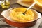 Half of cooked spaghetti squash and fork in dish on table, closeup