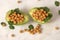 Half cut avocado with boiled chickpeas and parsley inside, vegan diet meal on marble background.