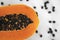 Half cut ripe papaya with seed on a white plate. Slices of sweet papaya with a white background. Halved papayas. Healthy