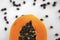 Half cut ripe papaya with seed on a white plate. Slices of sweet papaya with a white background. Halved papayas. Healthy