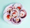 Half a dozen fresh opened scallop shell on white plate