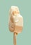 a half eaten cheese and lemon flavor popsicle on green background