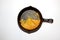 Half eaten pan of cornbread in a cast iron skillett isolated on