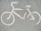 Half-erased sign of a Bicycle path on the asphalt. A path for bicyclists on the sidewalk.