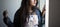 Half face portrait of an Indian Bengali beautiful and cute brunette girl in a casual blue jeans shirt and white top standing