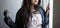 Half face portrait of an Indian Bengali beautiful and cute brunette girl in a casual blue jeans shirt and white top standing
