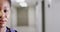 Half face video portrait of smiling african american female doctor in corridor, with copy space