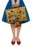 Half of the female figure holding a retro suitcase with stickers