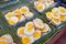 Half fried eggs for sale on Bangkok street