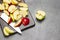 Half a green apple. Slices of green and red apples and kitchen knife on cutting board